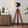 Black wood tripod floor lamp with rotatable round spotlight shade