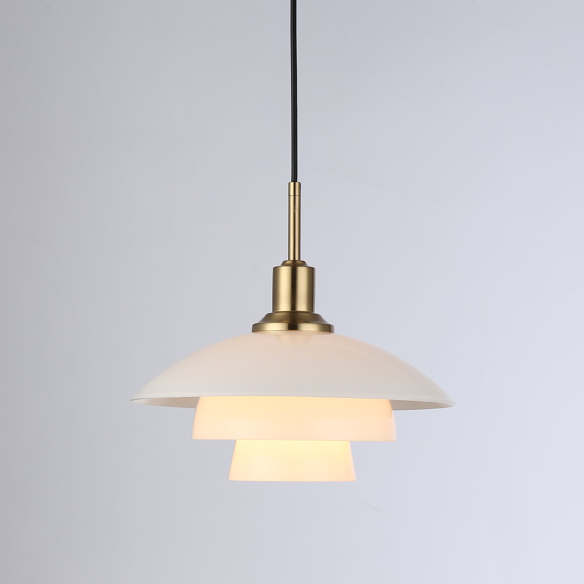 Layered multi-tier pendant light in brass gold with warm white shades