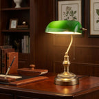 Green glass banker’s table lamp with antique bronze base and pull chain