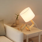 Adjustable natural wood articulated table lamp with white fabric drum shade