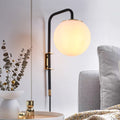 Opal globe plug-in wall sconce with matte black arm and brass accents